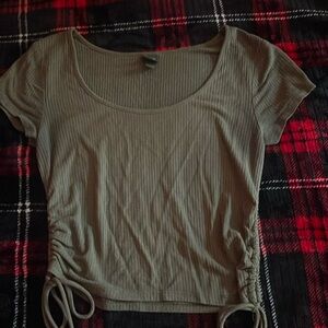 A green crop top with drawstring ruched sides. Size small.